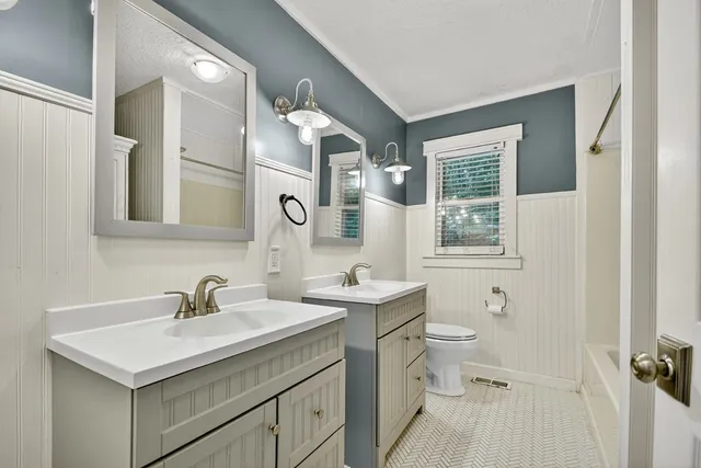 a bathroom with a sink toilet and mirror
