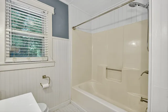 a bathroom with a bathtub and a shower
