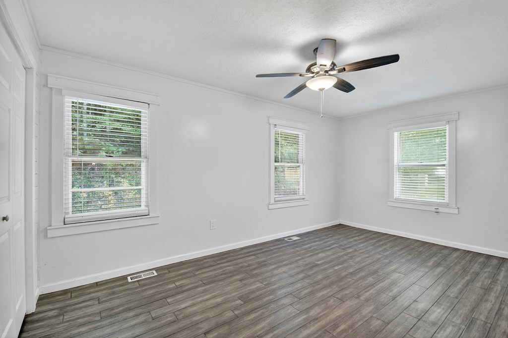 1146 Galloway Road Blue Ridge, GA 30513 - Photo 14 of 33 a view of an empty room with wooden floor and a window
