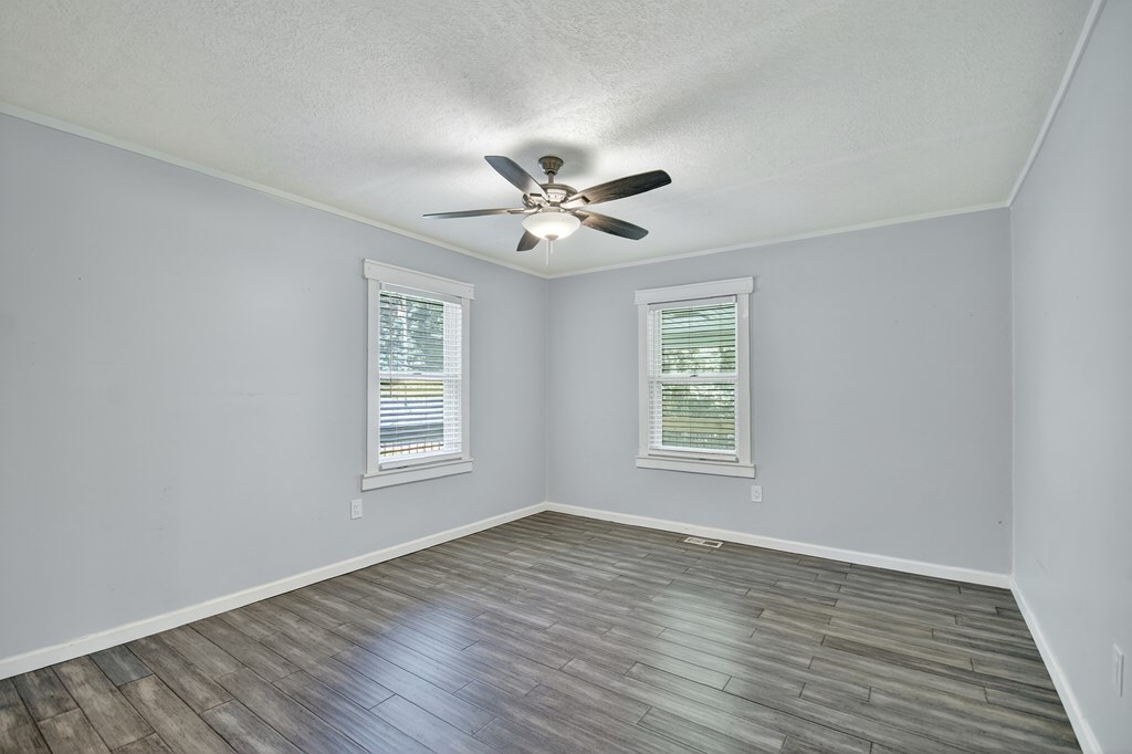 1146 Galloway Road Blue Ridge, GA 30513 - Photo 15 of 33 an empty room with wooden floor and windows