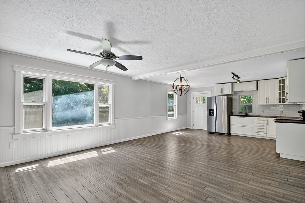 1146 Galloway Road Blue Ridge, GA 30513 - Photo 16 of 33 a view of a livingroom with wooden floor and a ceiling fan