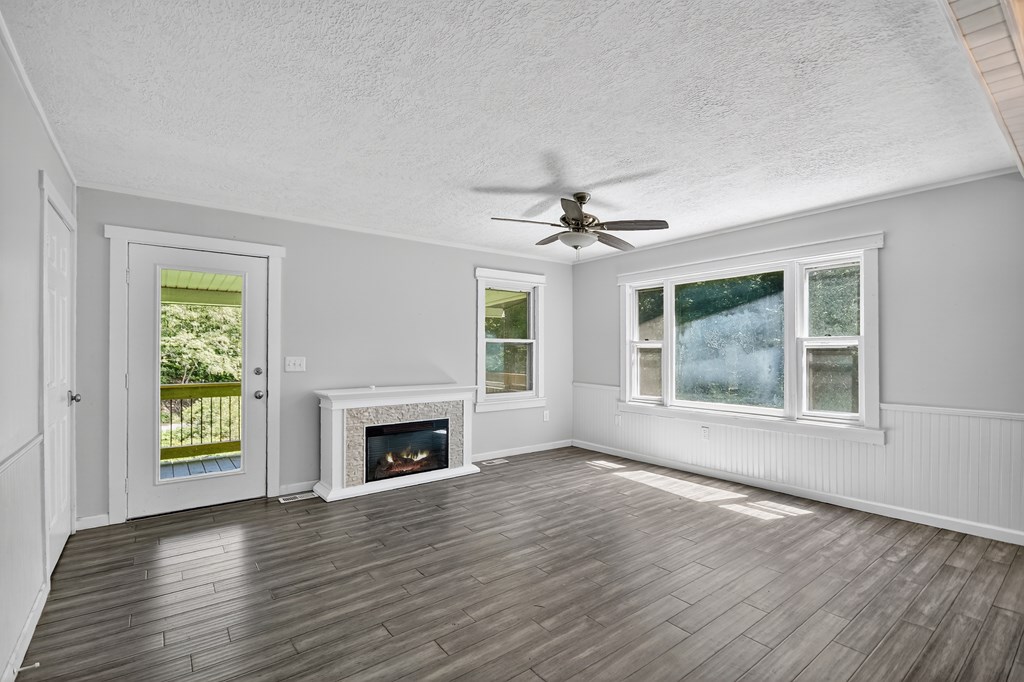 1146 Galloway Road Blue Ridge, GA 30513 - Photo 4 of 33 a view of an empty room with a window and wooden floor