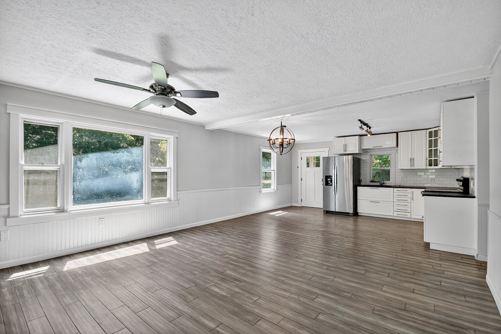 1146 Galloway Road Blue Ridge, GA 30513 - Photo 5 of 33 a view of a kitchen with wooden floor and a ceiling fan