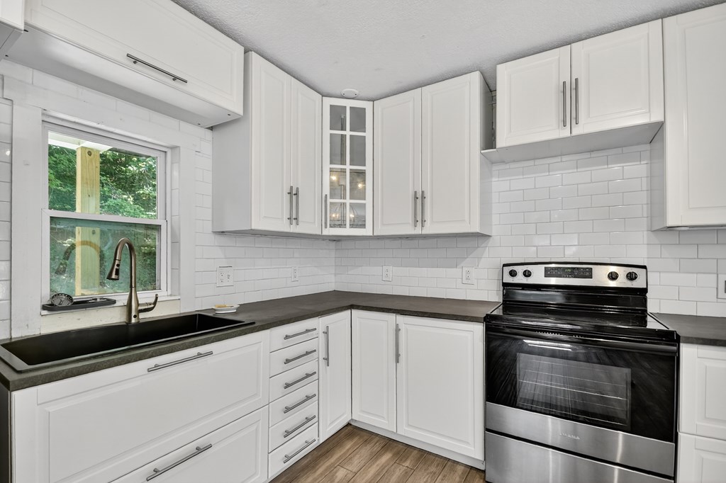 1146 Galloway Road Blue Ridge, GA 30513 - Photo 8 of 33 a kitchen with granite countertop white cabinets and appliances
