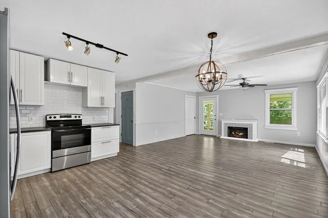 a kitchen with granite countertop a stove and a fireplace