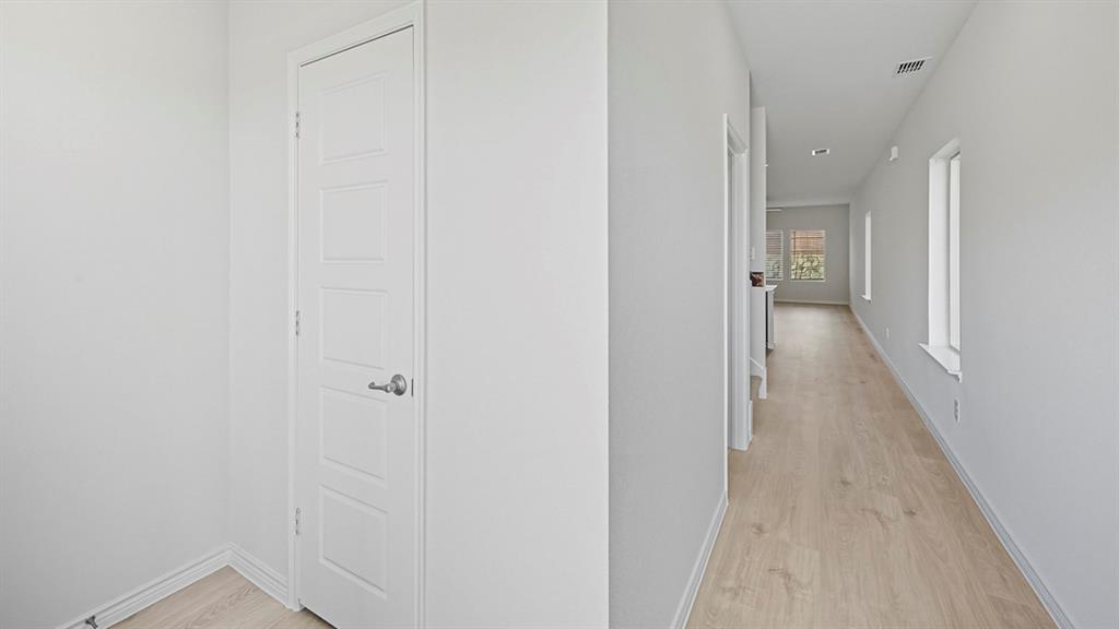 3421 Amaretto Road Aubrey, TX 76227 - Photo 20 of 38 a view of a hallway with wooden floor