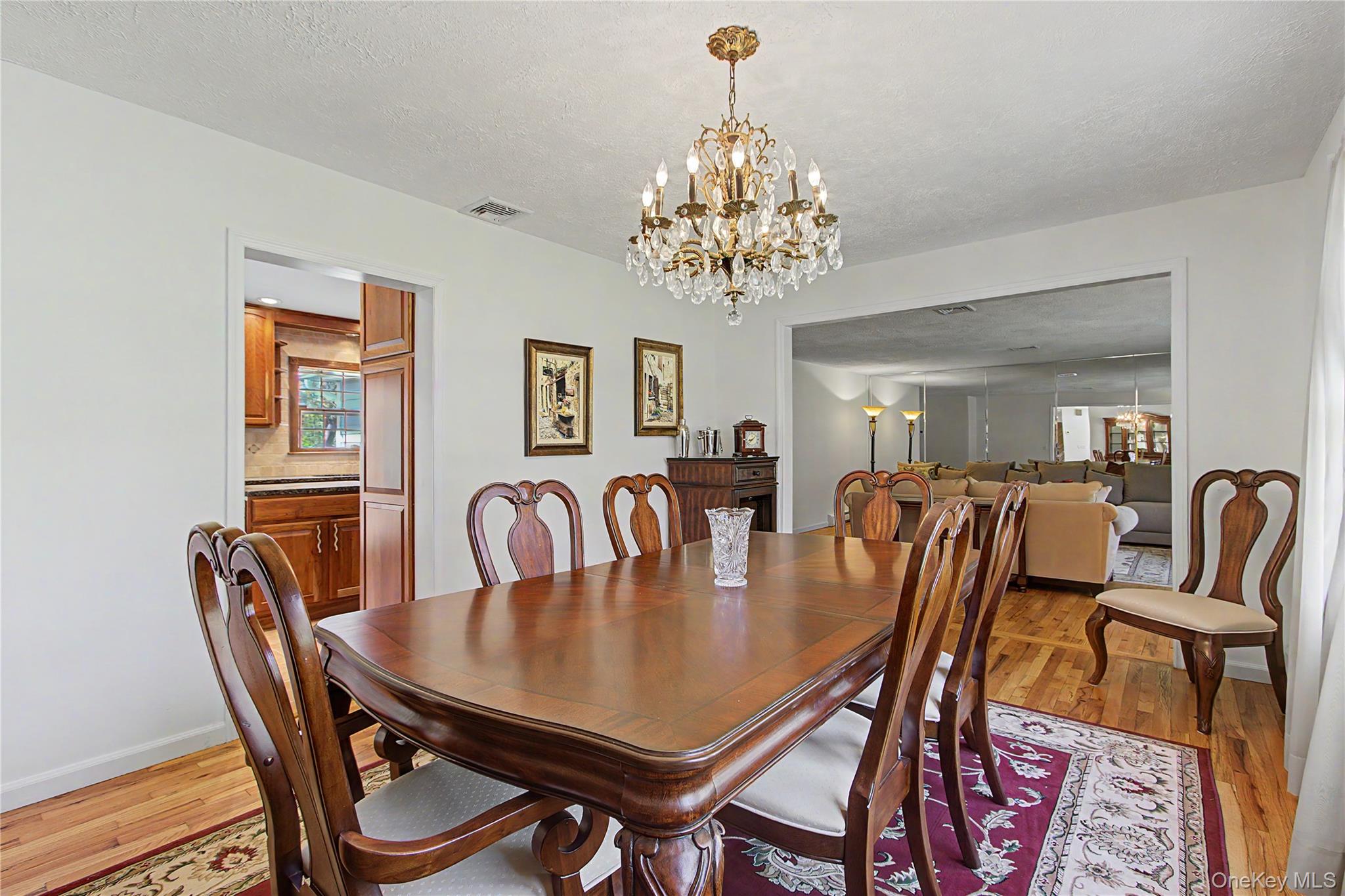 24 Richard Road Mahopac, NY 10541 - Photo 11 of 47 a view of a dining room with furniture a chandelier and wooden floor