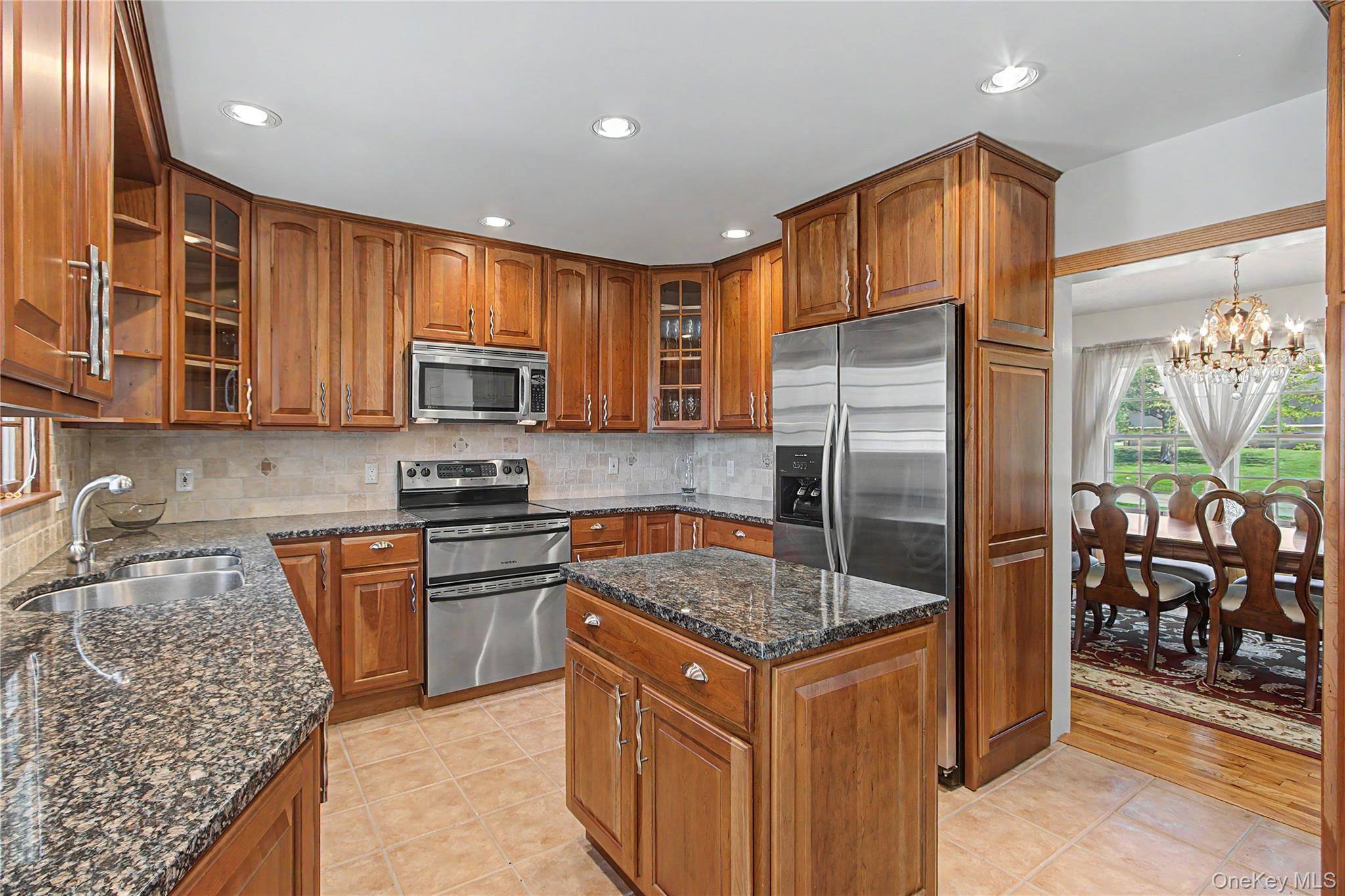24 Richard Road Mahopac, NY 10541 - Photo 12 of 47 a kitchen with stainless steel appliances granite countertop a stove top oven a sink and a refrigerator