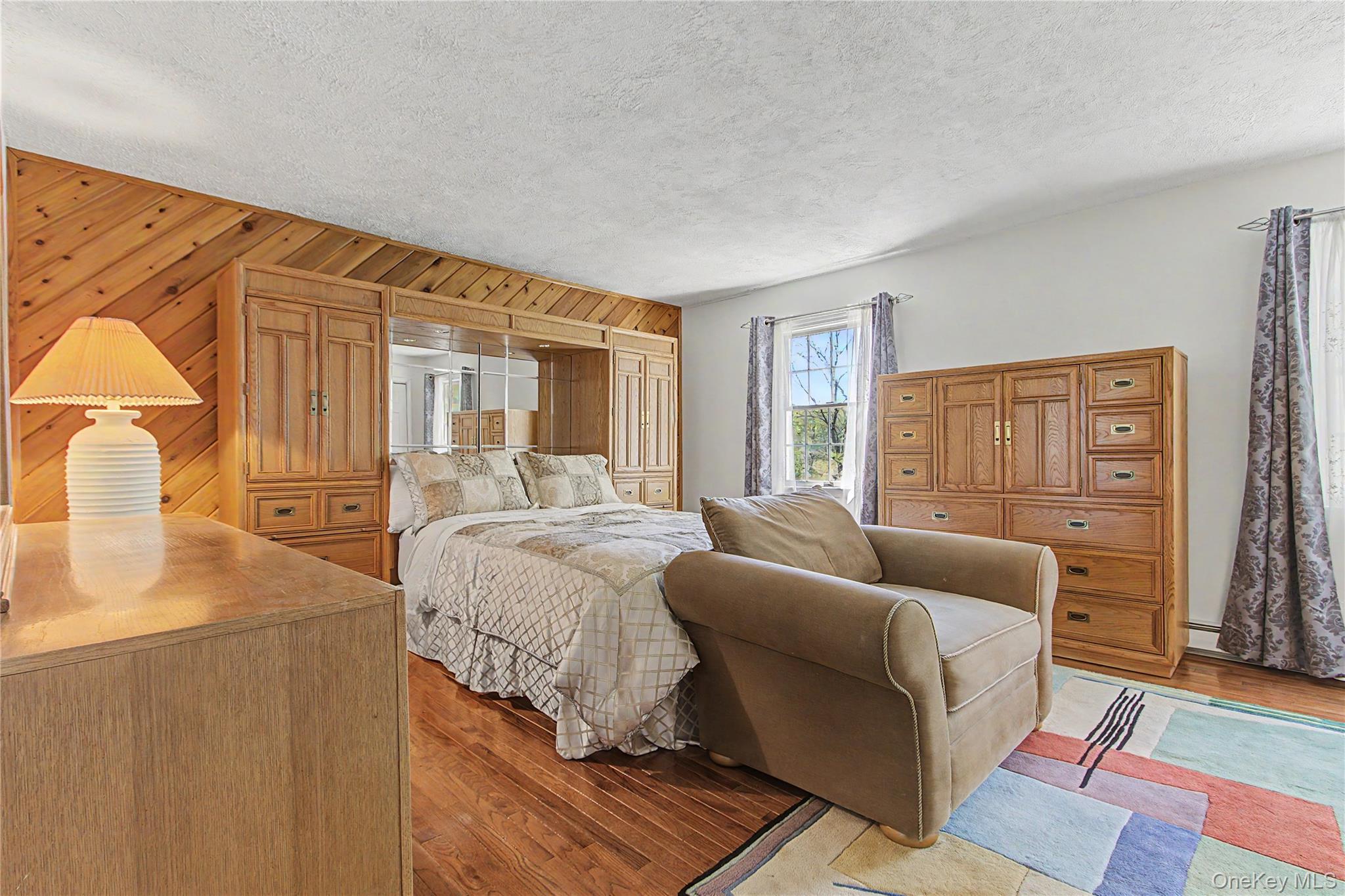 24 Richard Road Mahopac, NY 10541 - Photo 19 of 47 a bedroom with a bed and wooden floor