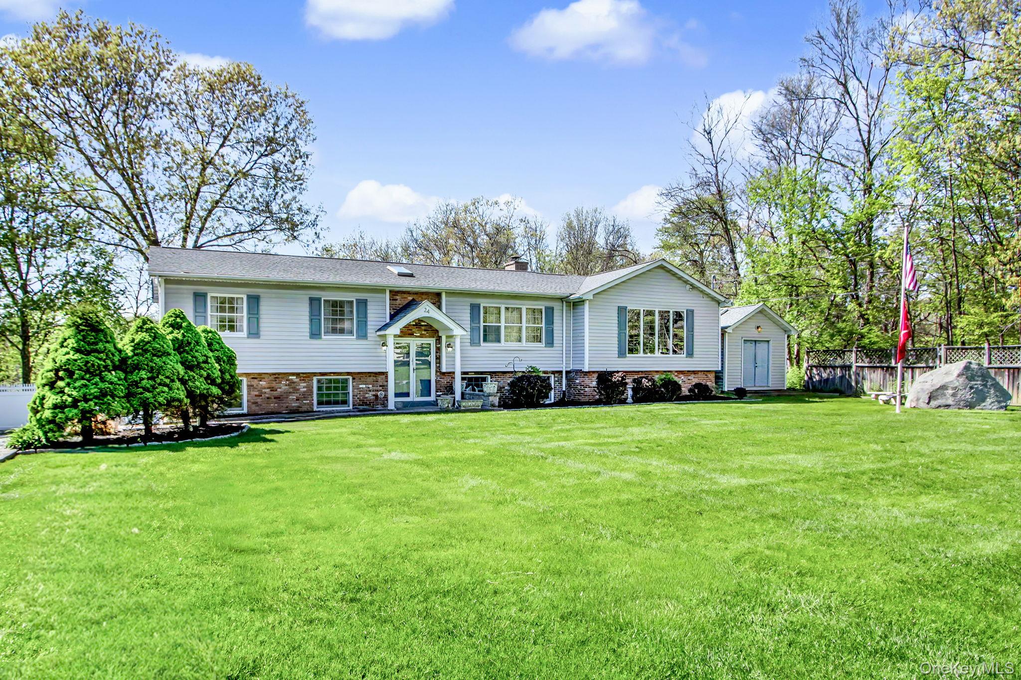 24 Richard Road Mahopac, NY 10541 - Photo 2 of 47 a front view of a house with a garden