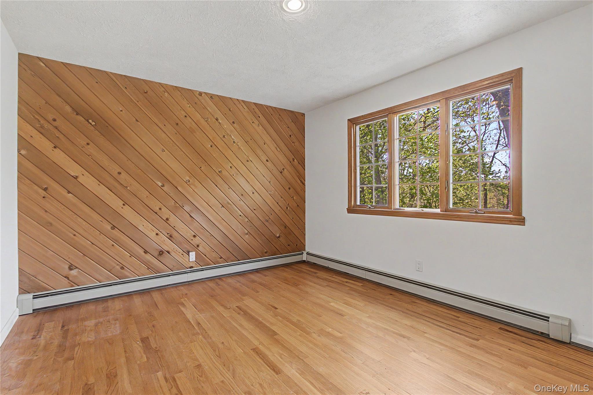 24 Richard Road Mahopac, NY 10541 - Photo 25 of 47 a view of an empty room with a window and wooden floor