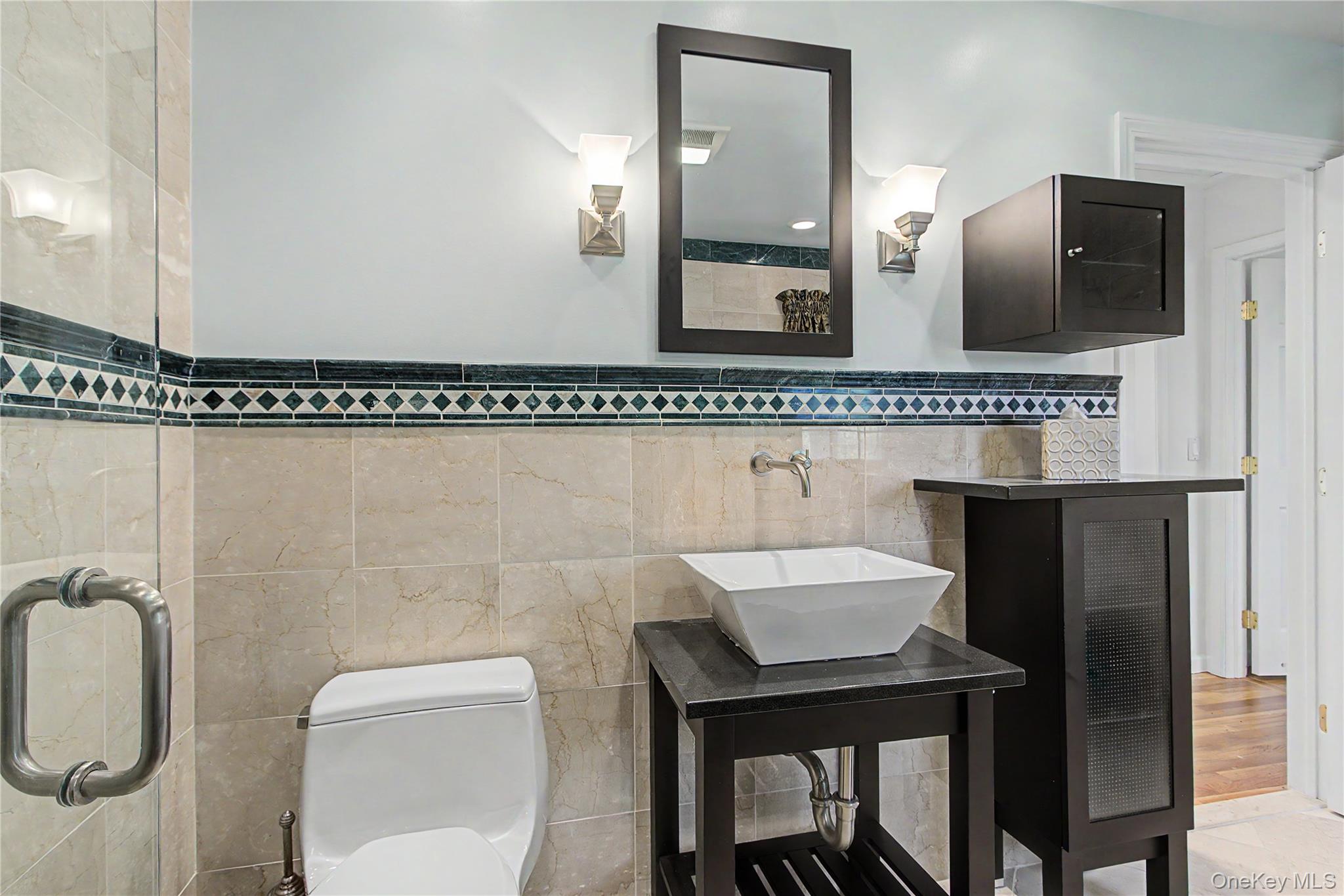 24 Richard Road Mahopac, NY 10541 - Photo 28 of 47 a bathroom with a toilet a sink and mirror