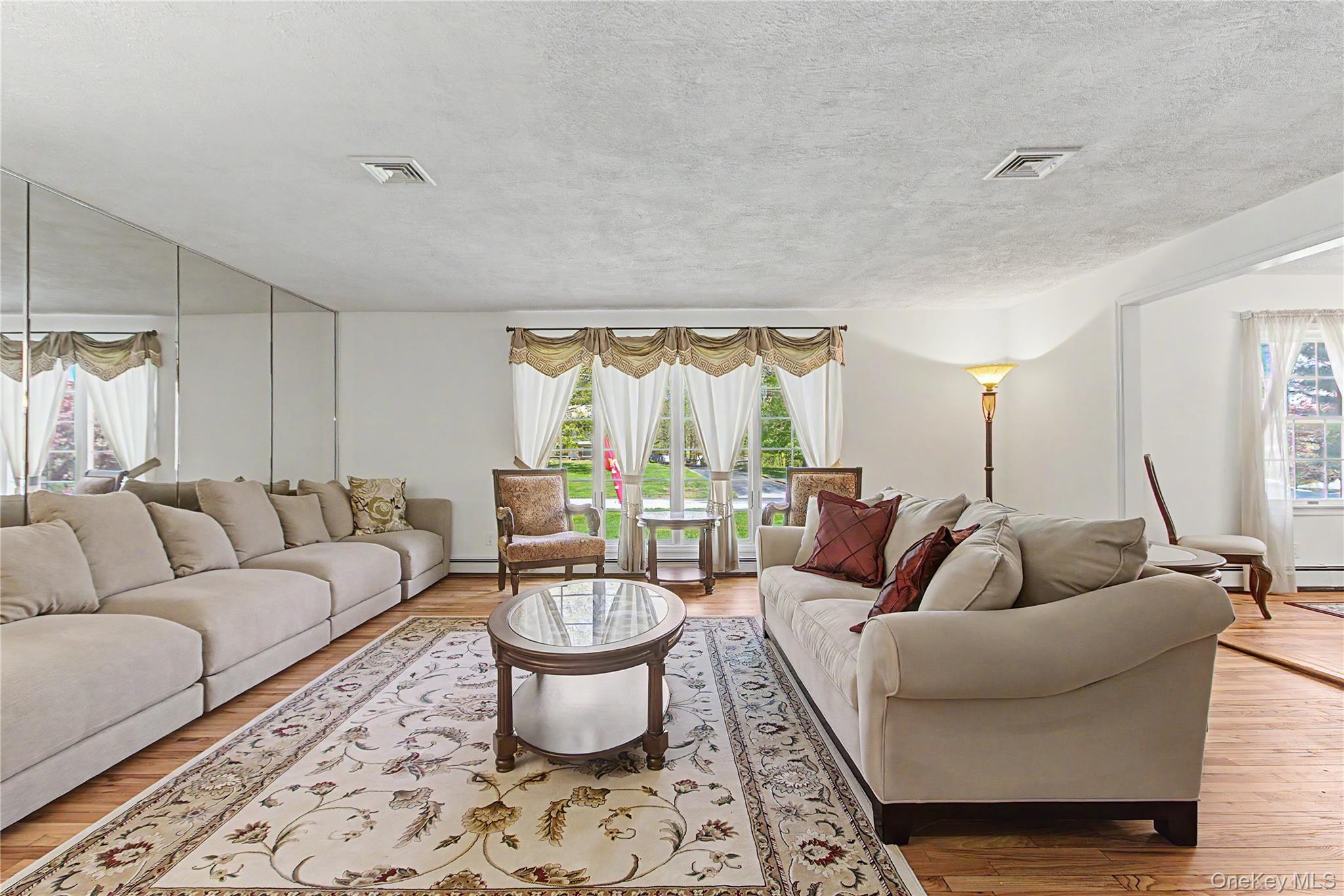 24 Richard Road Mahopac, NY 10541 - Photo 3 of 47 a living room with furniture a lamp a rug and a large window