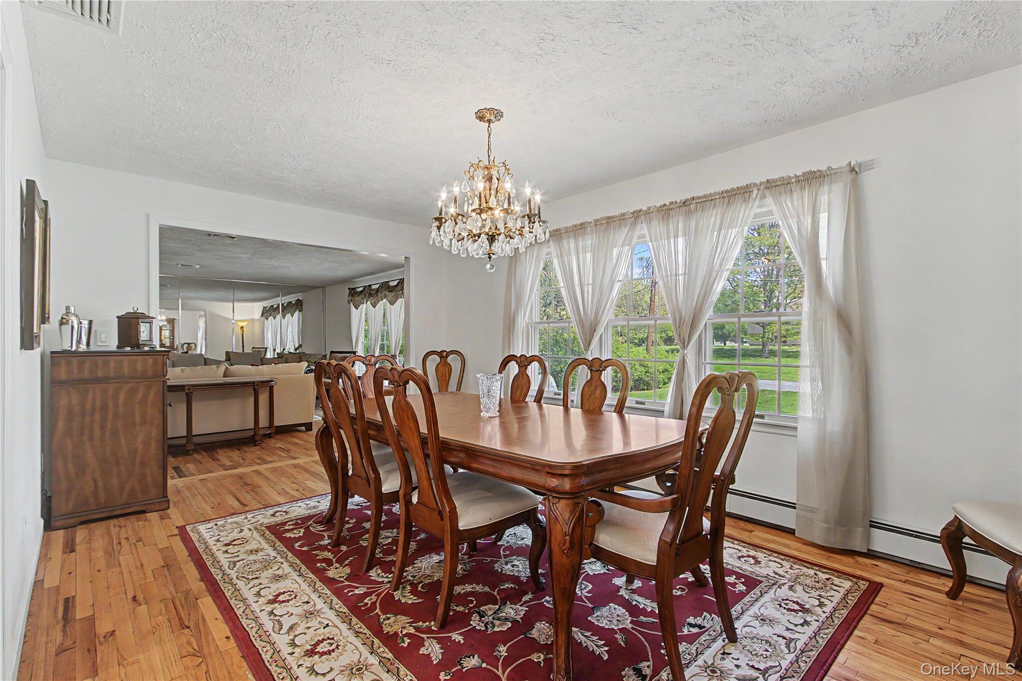 24 Richard Road Mahopac, NY 10541 - Photo 8 of 47 a dining room with furniture a rug and a chandelier