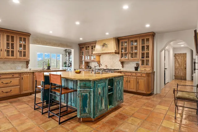 a bathroom with a granite countertop tub sink and mirror