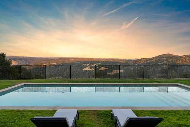 a view of a swimming pool with a yard