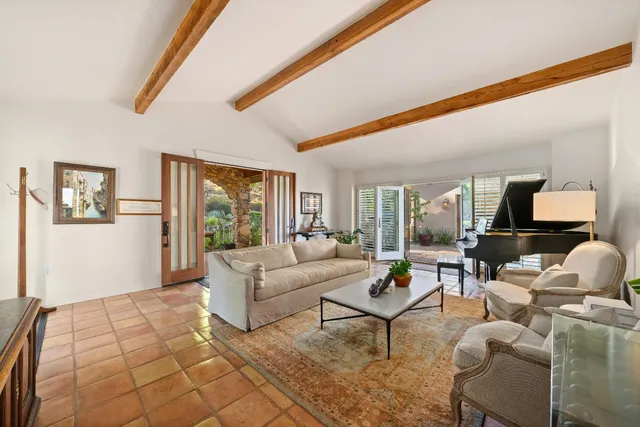 a living room with fireplace furniture and a large window