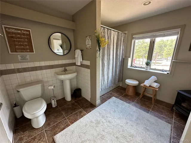 a bathroom with a toilet sink and mirror