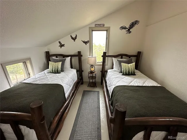 a utility room with stainless steel appliances a stove a microwave and a refrigerator