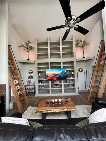 a living room with furniture a rug and a window