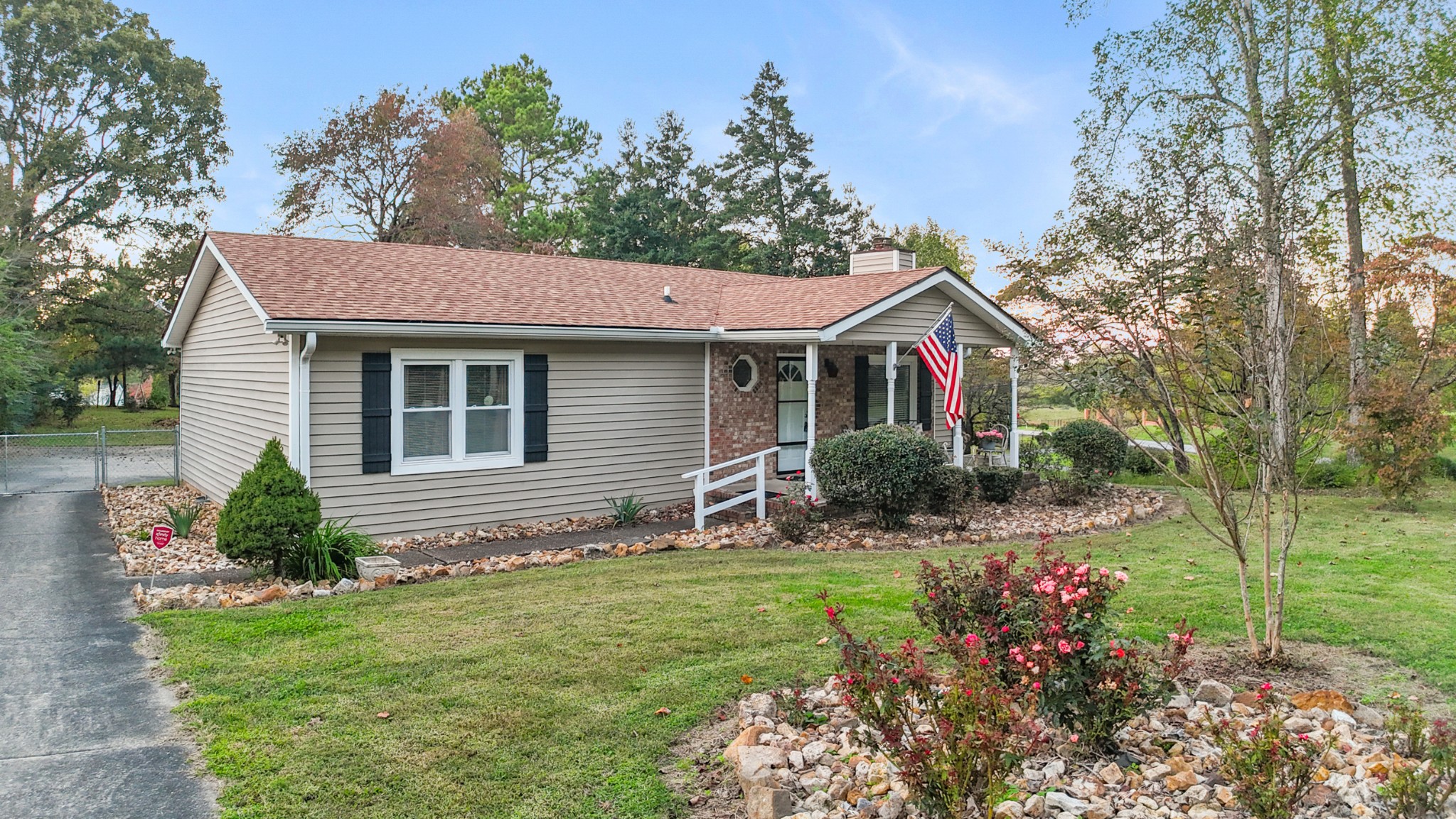 a front view of a house with a yard and potted plants