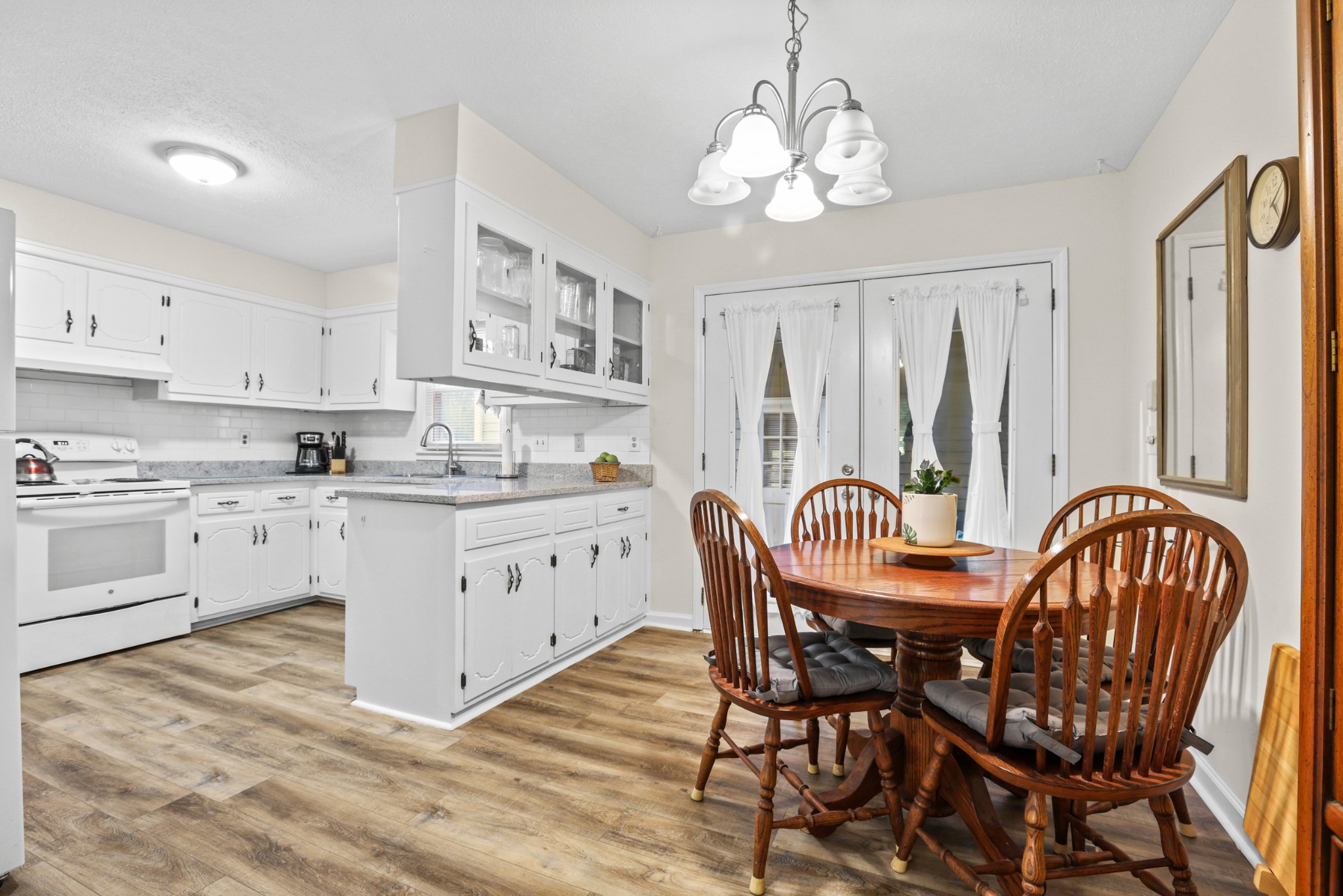236 Old Columbia Road Dickson, TN 37055 - Photo 8 of 26 a kitchen with stainless steel appliances granite countertop a white table and chairs