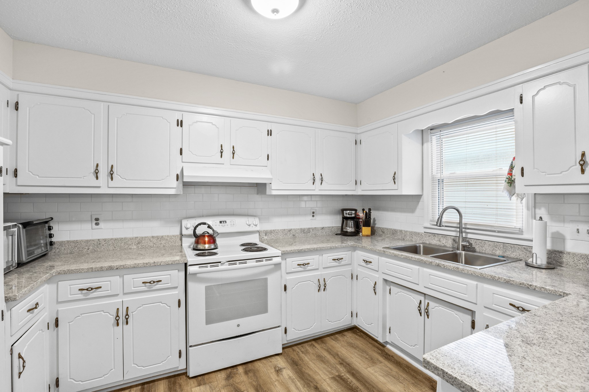 236 Old Columbia Road Dickson, TN 37055 - Photo 9 of 26 a kitchen with white cabinets white stainless steel appliances and sink