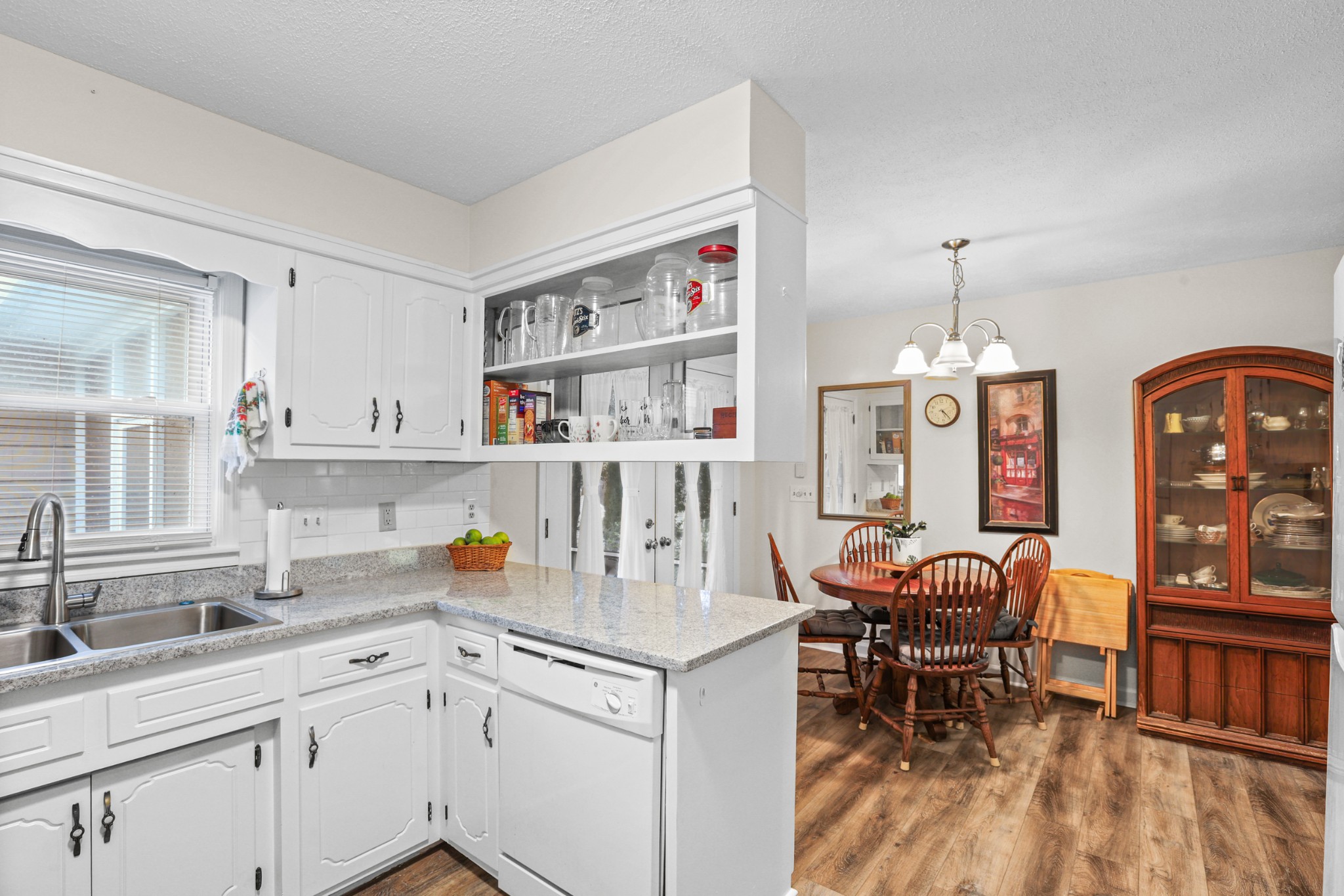 236 Old Columbia Road Dickson, TN 37055 - Photo 10 of 26 a kitchen with a dining table cabinets appliances and wooden floor