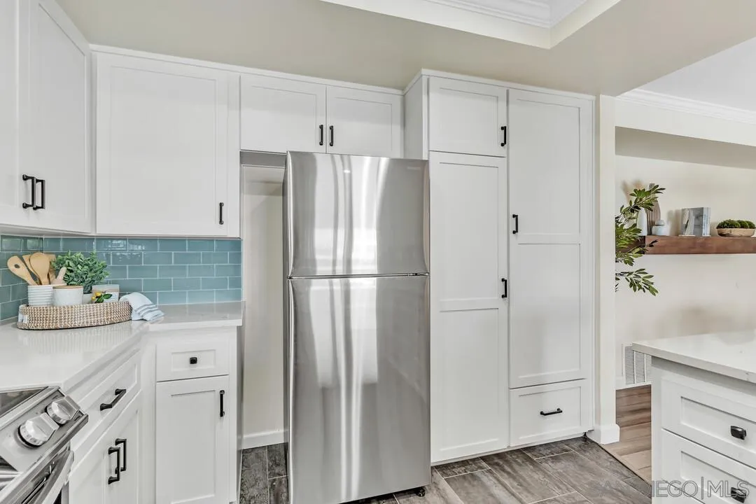 24 Montego Court Coronado, CA 92118 - Photo 18 of 71 a kitchen with white cabinets and refrigerator
