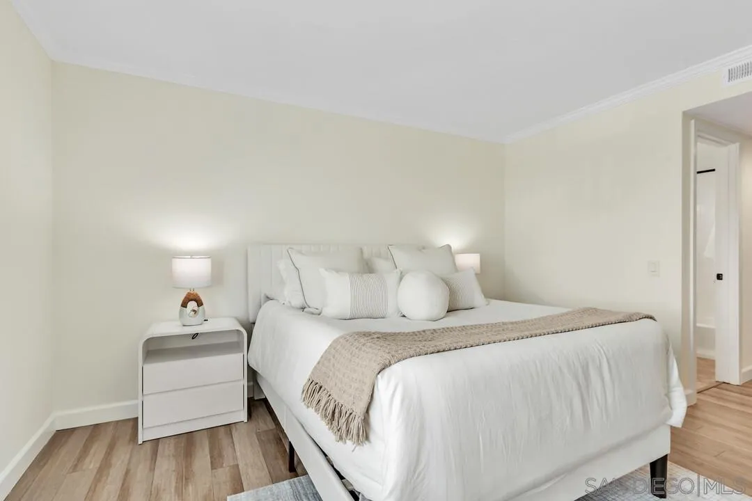 24 Montego Court Coronado, CA 92118 - Photo 24 of 71 a bedroom with a bed and a wooden floor