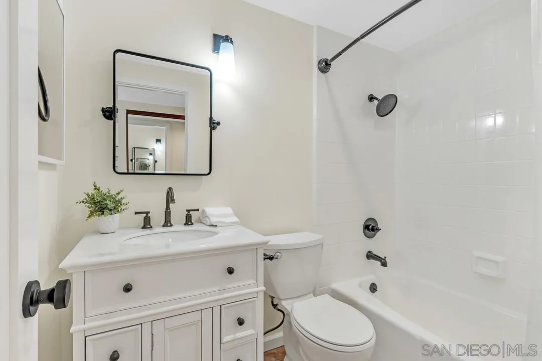24 Montego Court Coronado, CA 92118 - Photo 27 of 71 a bathroom with a toilet sink vanity tub and mirror