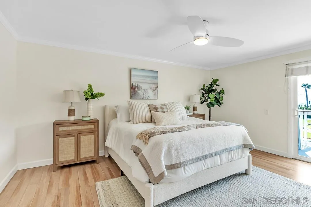 24 Montego Court Coronado, CA 92118 - Photo 29 of 71 a bedroom with a large bed and a chandelier