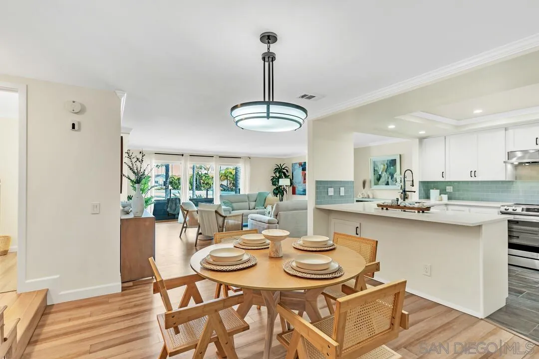 24 Montego Court Coronado, CA 92118 - Photo 10 of 71 a dining room with furniture a chandelier and wooden floor