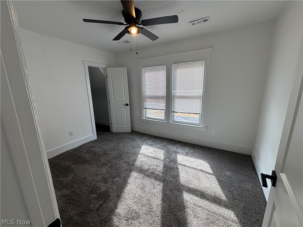 4115 Whitman Avenue, Unit UP Cleveland, OH 44113 - Photo 6 of 12 Unfurnished bedroom featuring carpet flooring, a spacious closet, and ceiling fan