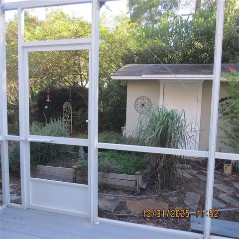 a view of a wooden door and a yard