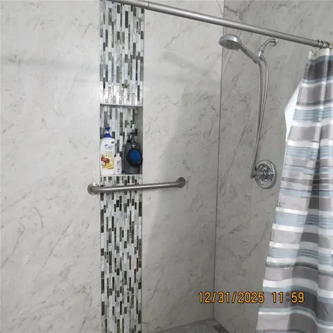 a bathroom with a shower and a sink