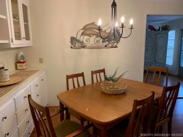 a view of a dining room with furniture and chandelier