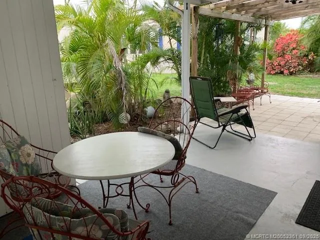 a view of a chairs and table in patio