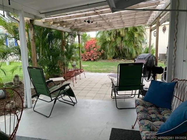 a backyard of a house with outdoor seating