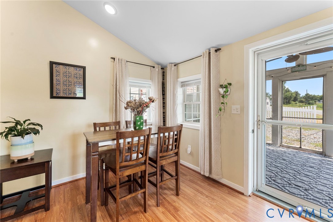 110 Hampton Road Dunnsville, VA 22454 - Photo 11 of 40 a view of a dining room with furniture window and wooden floor