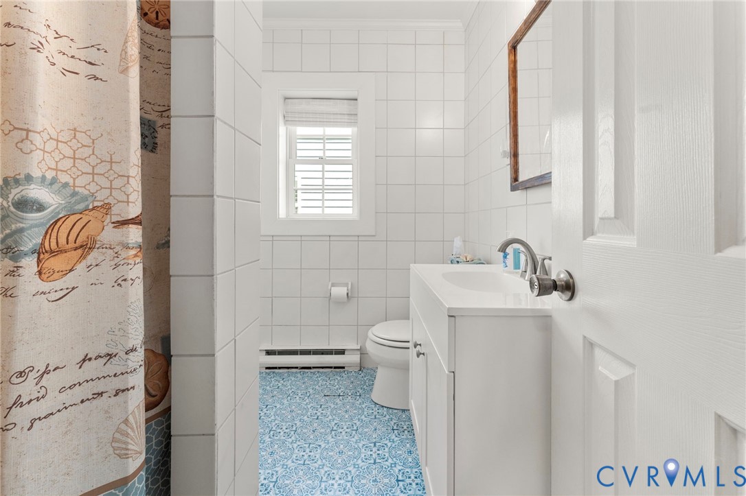 110 Hampton Road Dunnsville, VA 22454 - Photo 15 of 40 a bathroom with a sink a toilet and shower