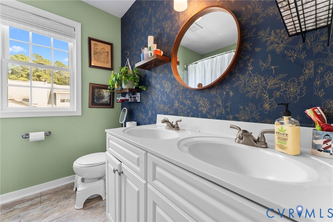 110 Hampton Road Dunnsville, VA 22454 - Photo 17 of 40 a bathroom with a toilet sink and mirror