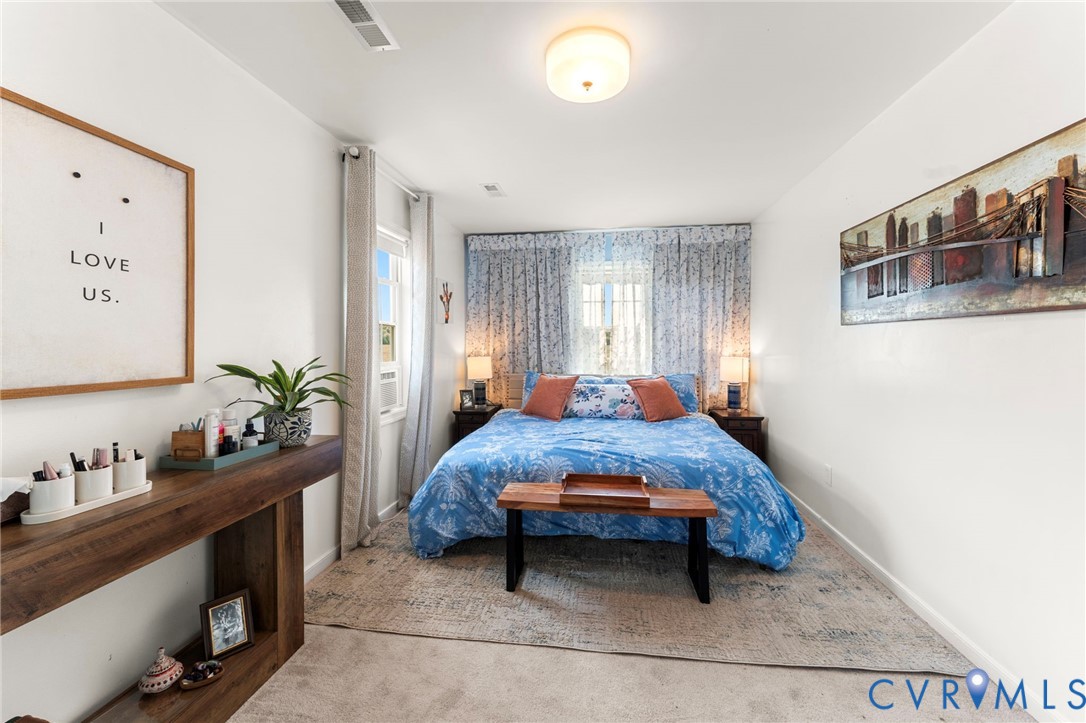 110 Hampton Road Dunnsville, VA 22454 - Photo 18 of 40 a bedroom with furniture and a window