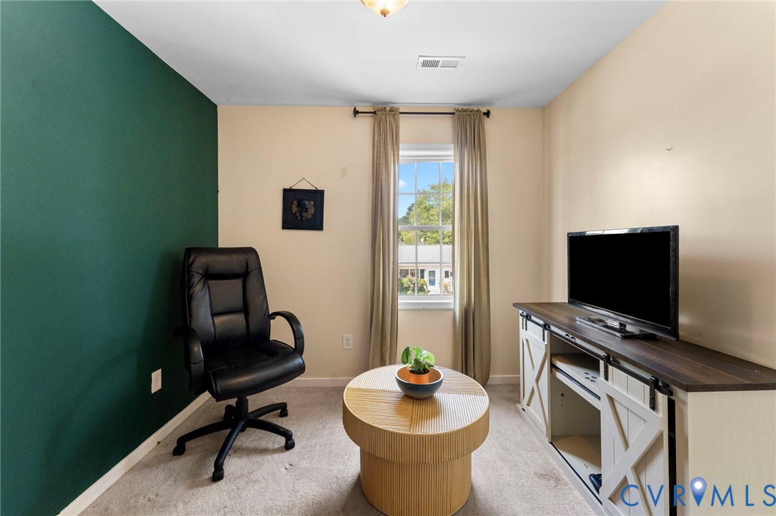 110 Hampton Road Dunnsville, VA 22454 - Photo 21 of 40 a living room with furniture and a flat screen tv