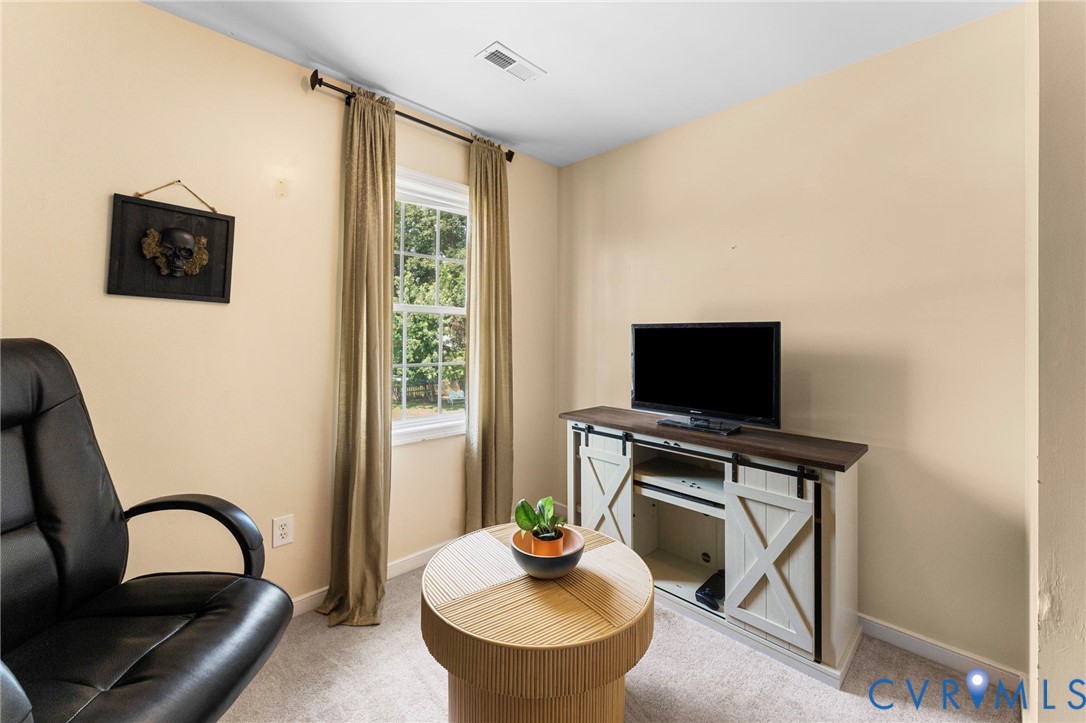 110 Hampton Road Dunnsville, VA 22454 - Photo 22 of 40 a living room with furniture and a flat screen tv