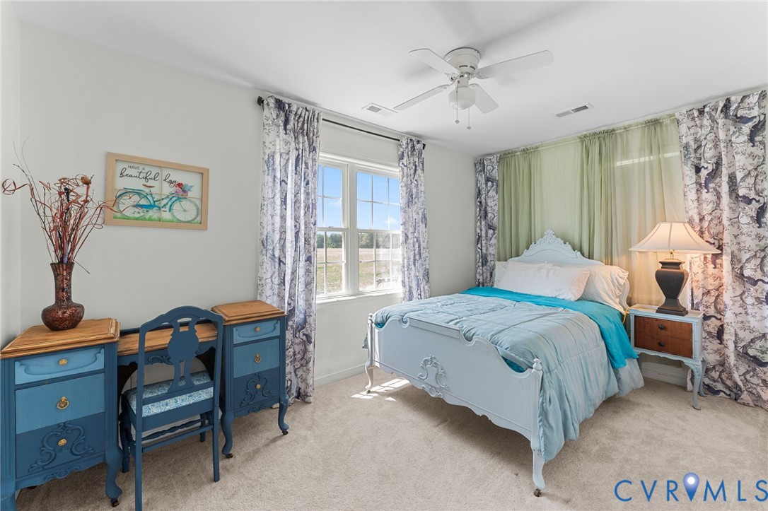 110 Hampton Road Dunnsville, VA 22454 - Photo 23 of 40 a bedroom with a bed and a table in it