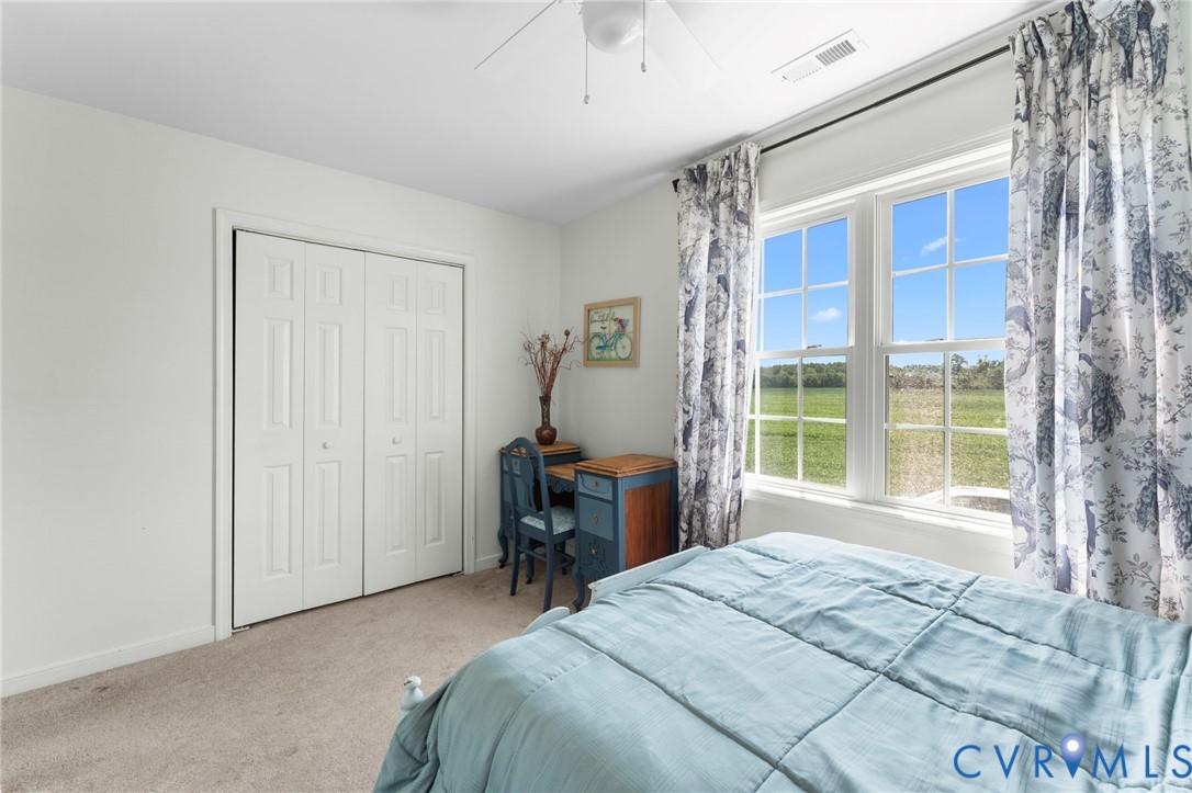 110 Hampton Road Dunnsville, VA 22454 - Photo 25 of 40 a bedroom with a large bed and a window