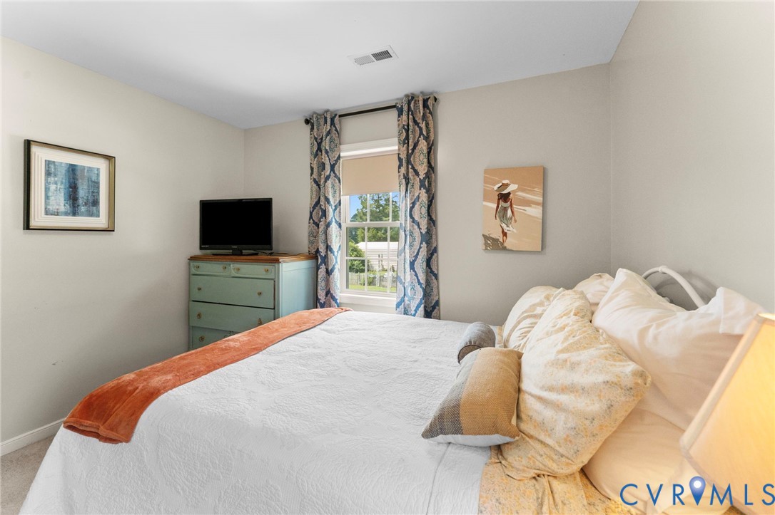 110 Hampton Road Dunnsville, VA 22454 - Photo 27 of 40 a bedroom with a bed and a flat screen tv