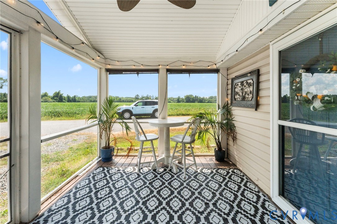110 Hampton Road Dunnsville, VA 22454 - Photo 29 of 40 a view of a patio with a table chairs and balcony