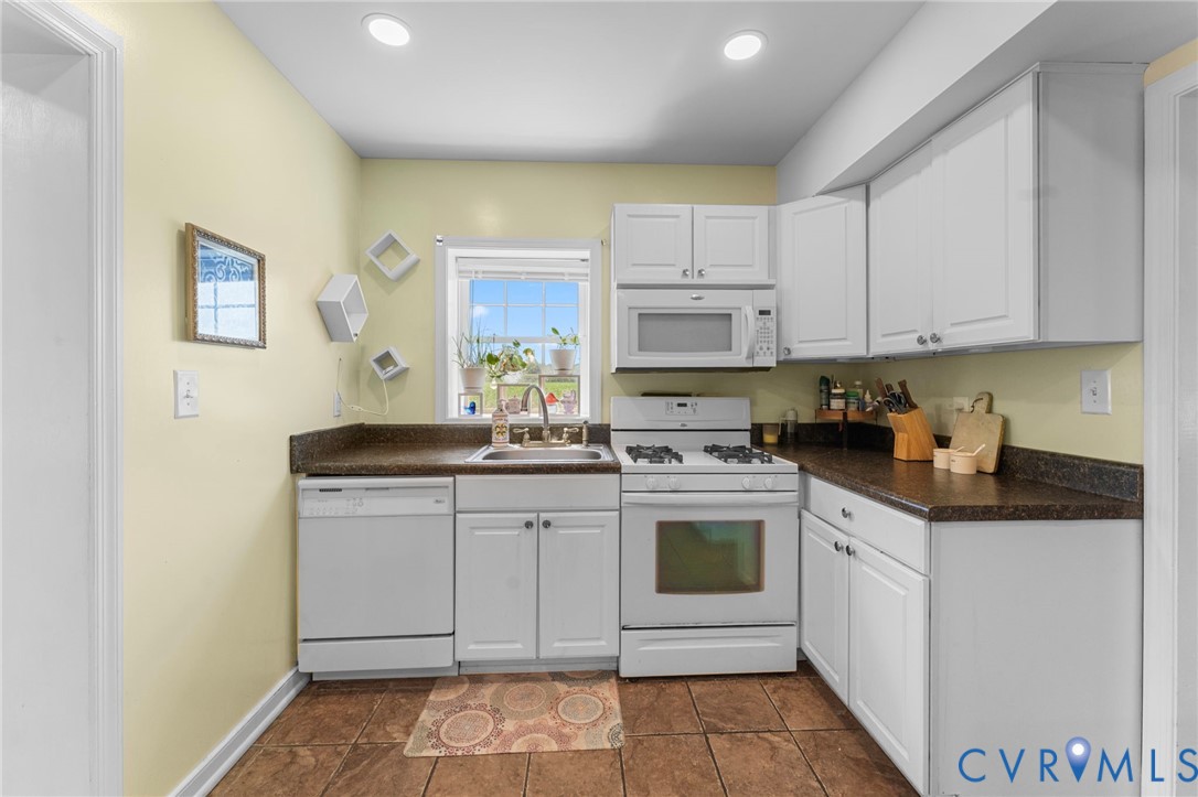 110 Hampton Road Dunnsville, VA 22454 - Photo 7 of 40 a kitchen with stainless steel appliances granite countertop a sink and cabinets